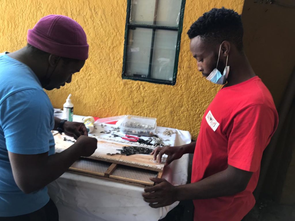 youth learning to make a mosaic